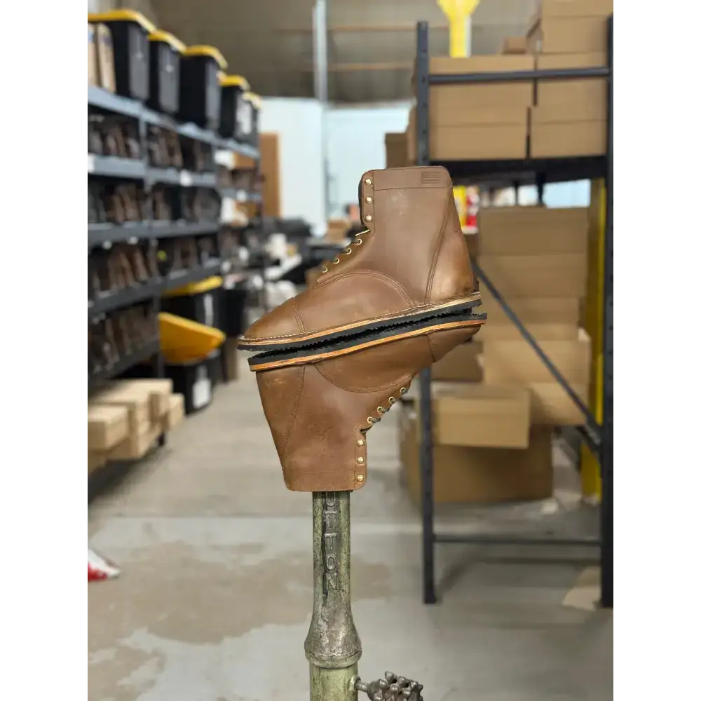 Brown leather work boot with brass eyelets, thick black sole from Barely Used Footwear