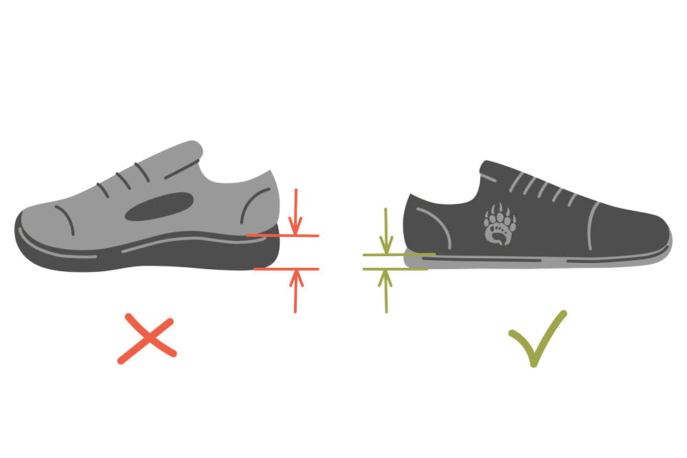Black zero-drop sneaker with paw print logo and gray sole