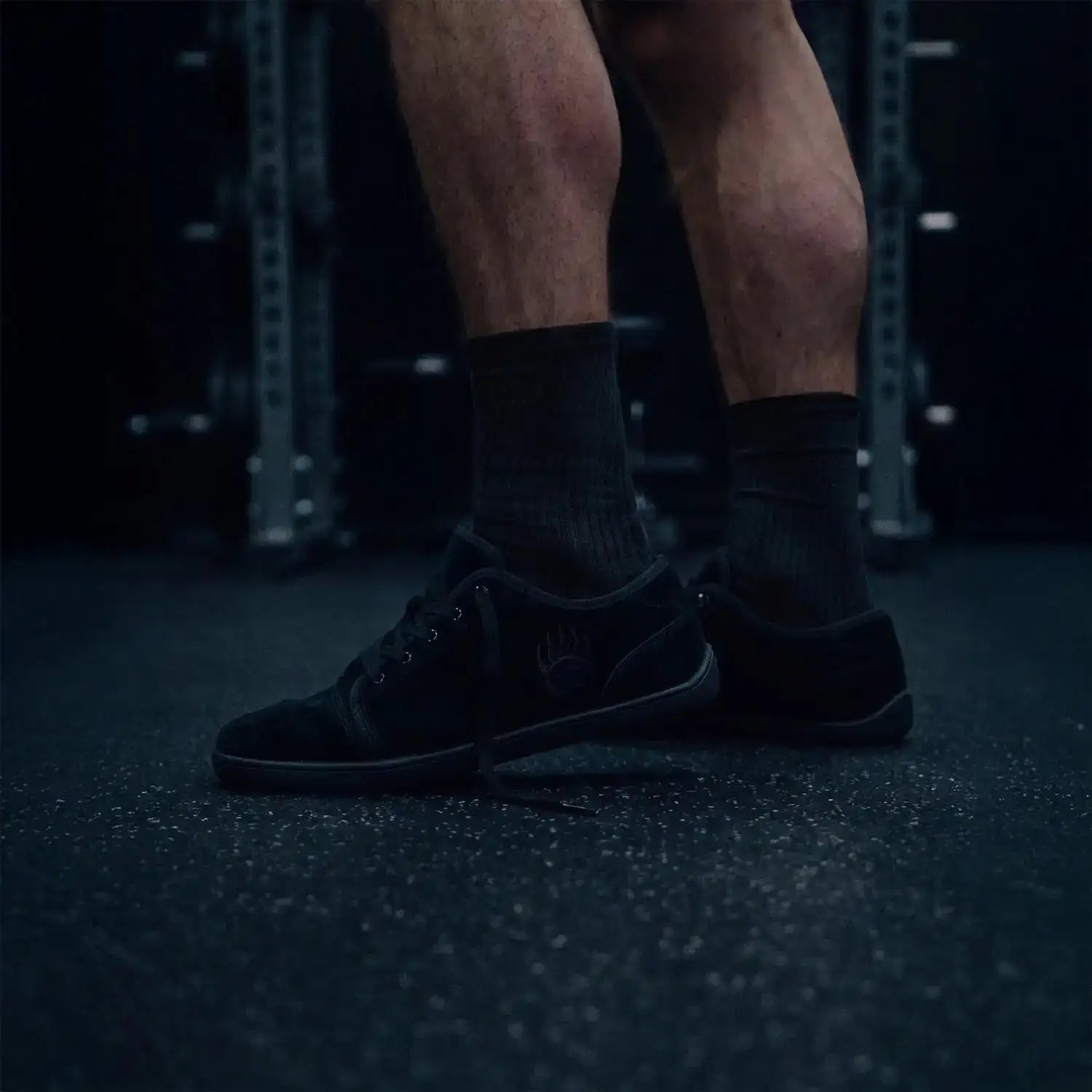 Black suede sneakers with a subtle logo on the side