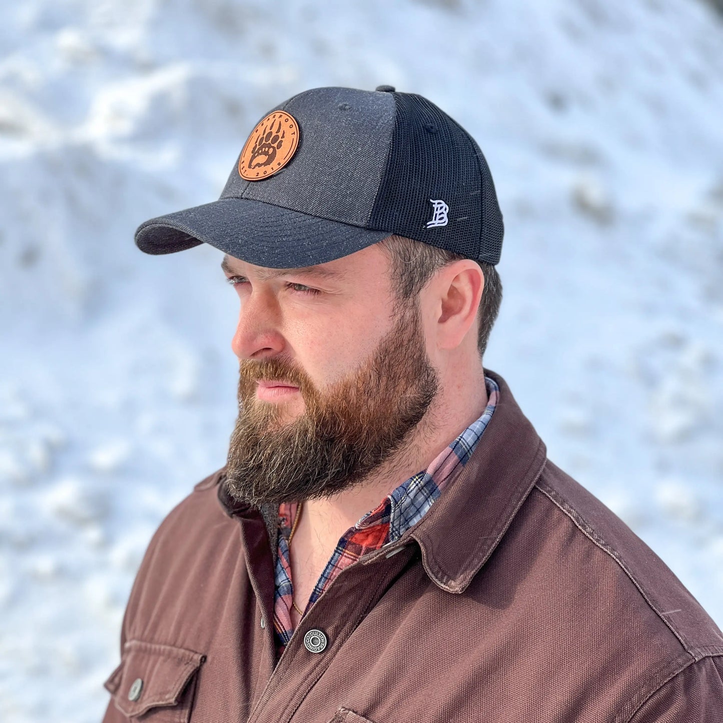 Navy blue Leather Patch Trucker Hat with brown leather patch logo