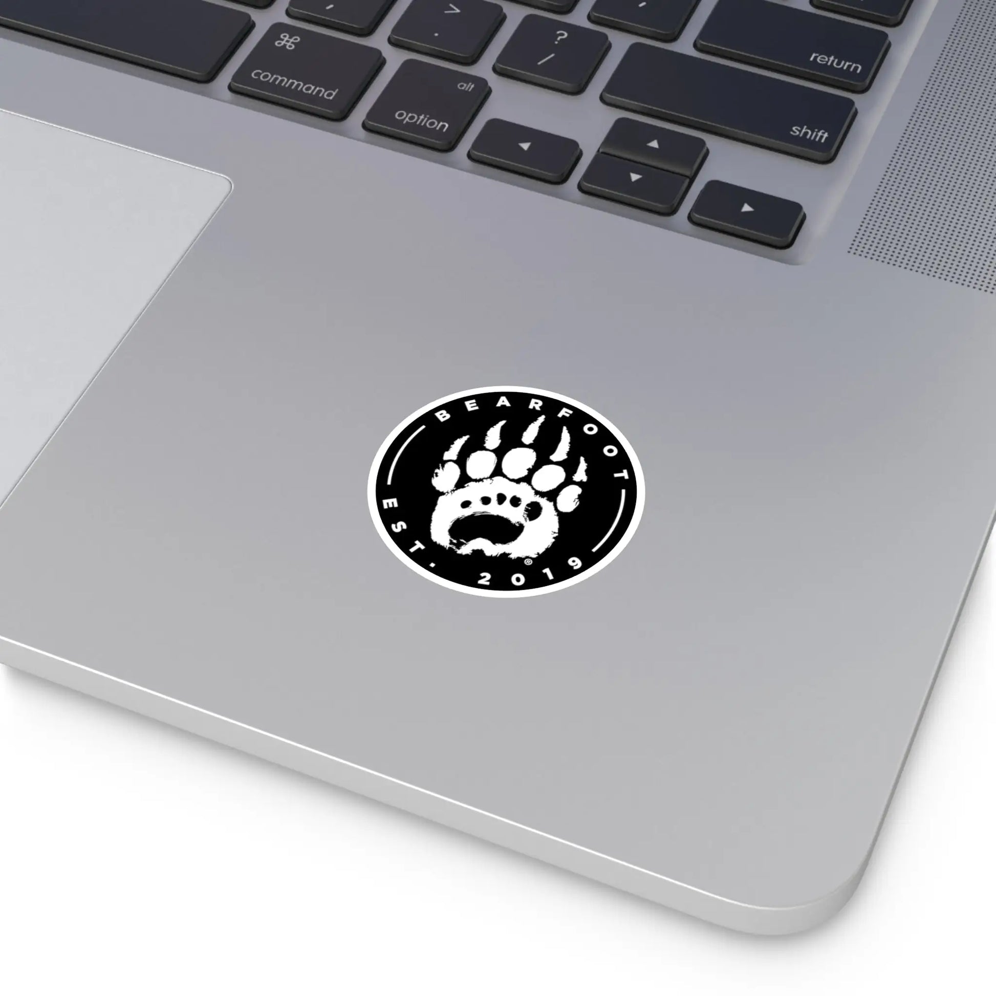 Black and white round stickers featuring a bear paw print and bearfoot est text with protective laminate in round shape