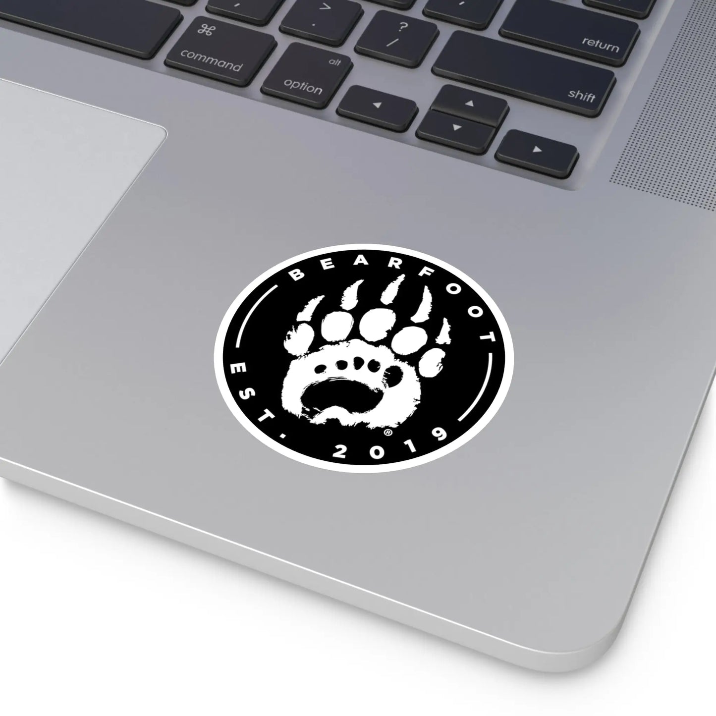 Black and white round stickers with a bear paw print and bearfoot est text featuring protective laminate and round shape