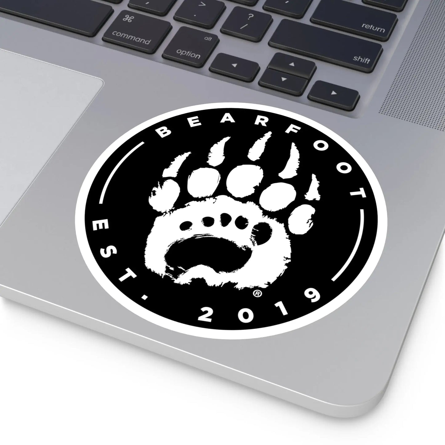 Black and white round stickers with stylized bear paw print and bearfoot text featuring protective laminate